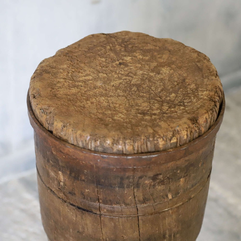A rustic three-legged French chopping block made from oak and elm with a textured wooden top. View IX