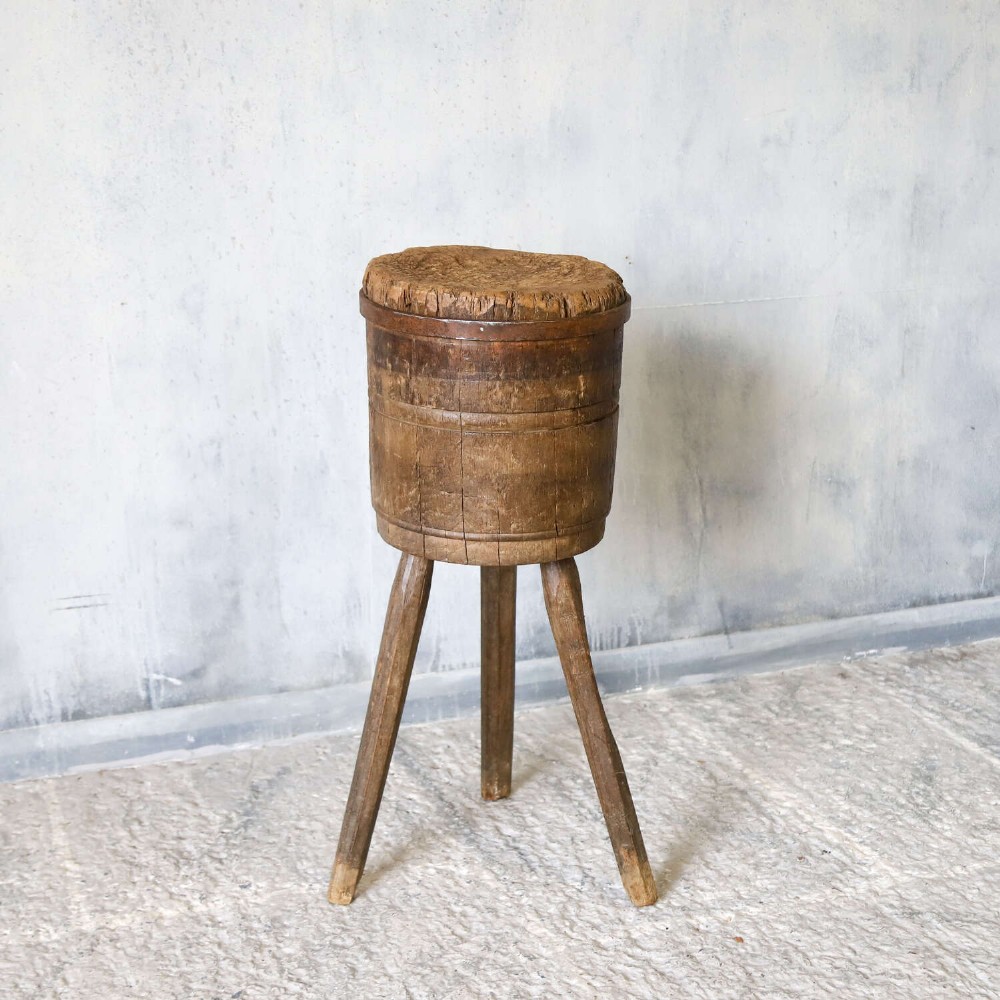 A rustic three-legged French chopping block made from oak and elm with a textured wooden top. View XI
