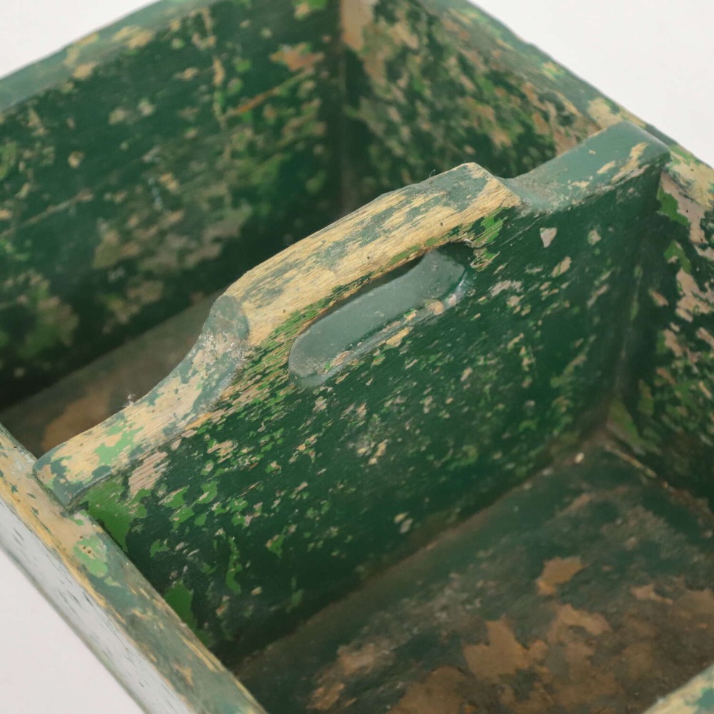 A rectangular dark green painted wooden caddy with a central carrying handle and two compartments, displaying worn paint along the edges. View VIII