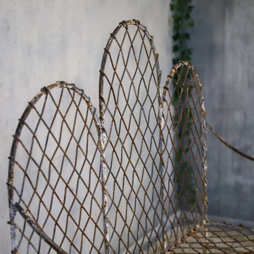 A French Gothic-influenced metal garden bench featuring a triple arched wirework backrest, lattice seat, and scrolled armrests and legs with a weathered, distressed paint finish. View XI