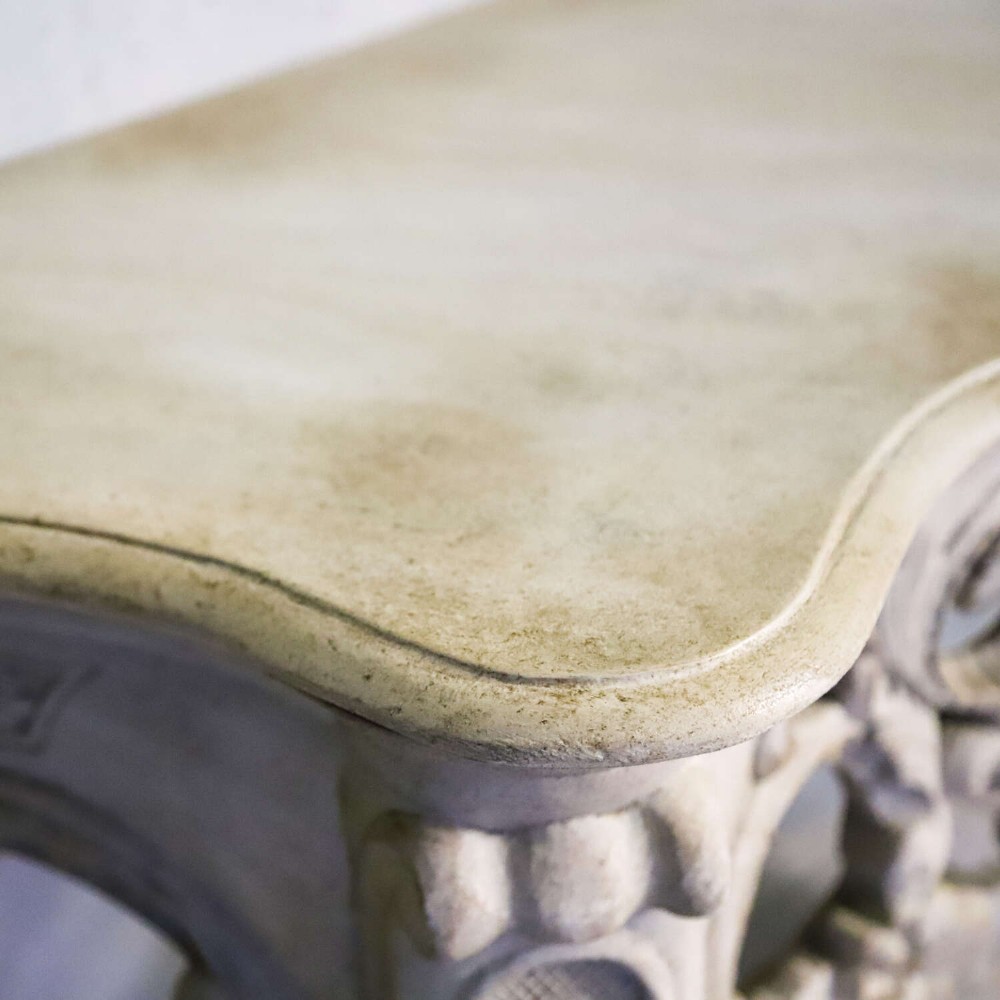 A pair of 1930s French wall console tables with intricate carved Rococo scrollwork in an antique white painted finish. View VII