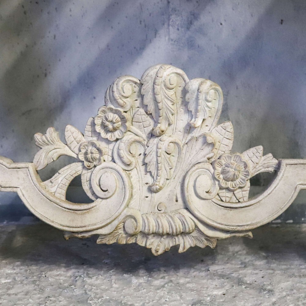 A pair of 1930s French wall console tables with intricate carved Rococo scrollwork in an antique white painted finish. View X