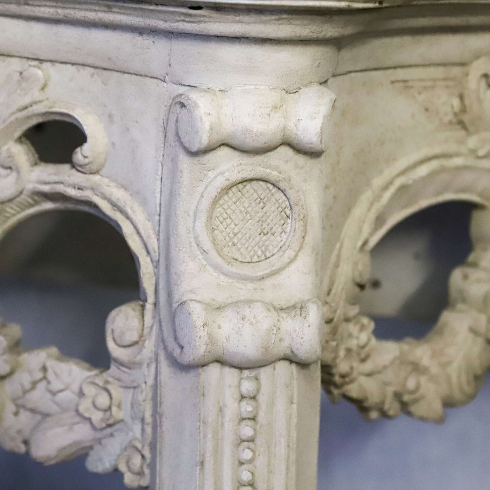 A pair of 1930s French wall console tables with intricate carved Rococo scrollwork in an antique white painted finish. View XI