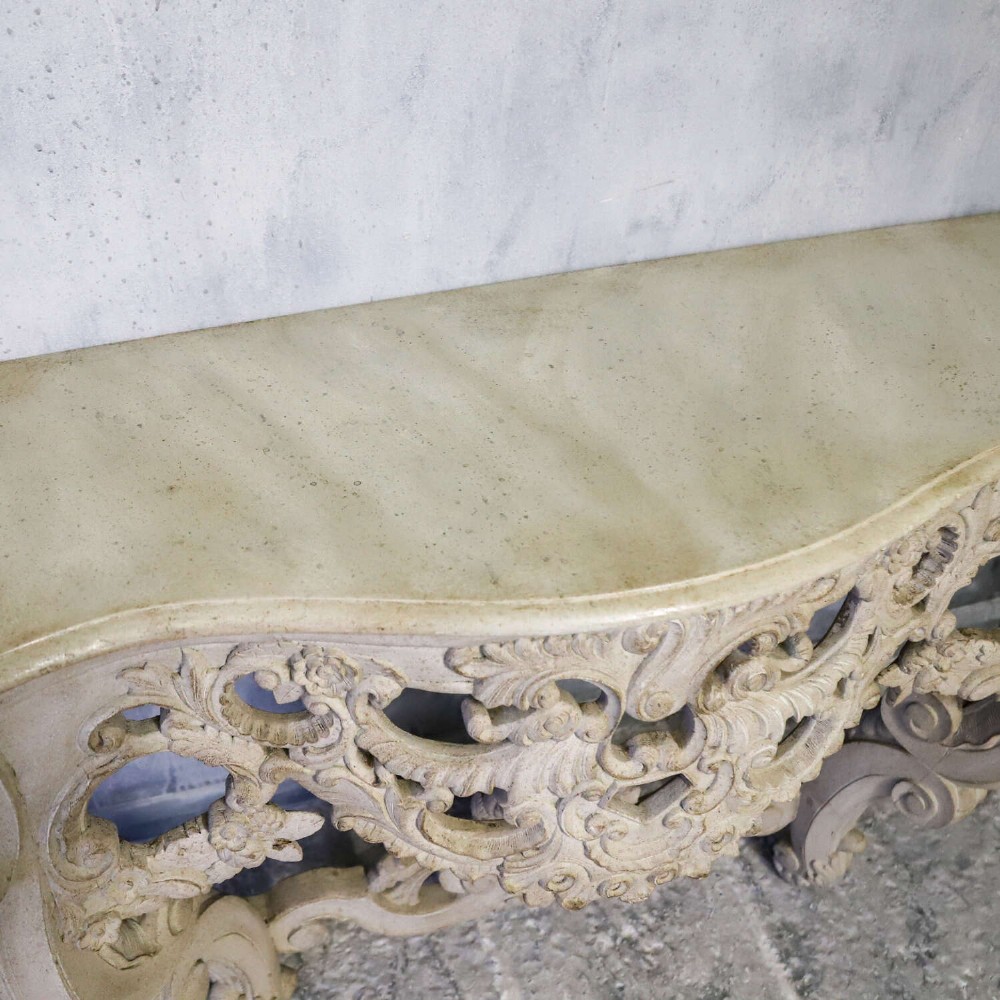 A pair of 1930s French wall console tables with intricate carved Rococo scrollwork in an antique white painted finish. View XII