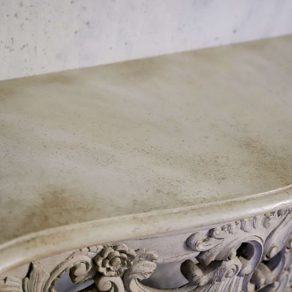 A pair of 1930s French wall console tables with intricate carved Rococo scrollwork in an antique white painted finish. View XV