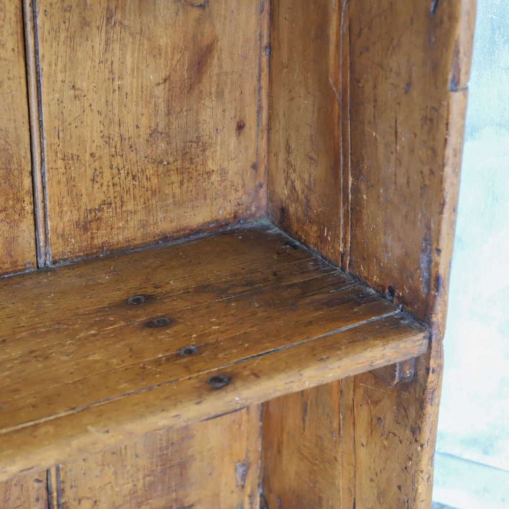 A 19th-century English country pine high-back settle bench with vertical timber panels and a warm honey brown finish. View III