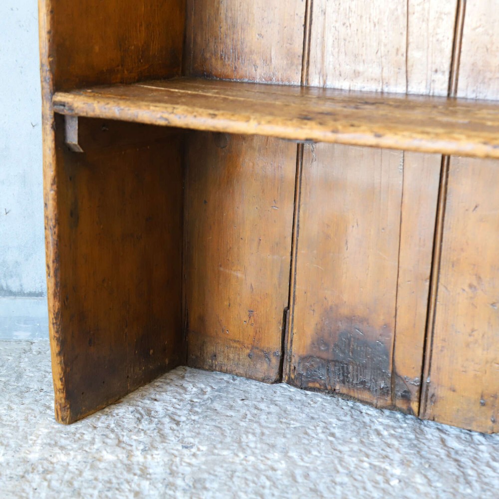A 19th-century English country pine high-back settle bench with vertical timber panels and a warm honey brown finish. View IV