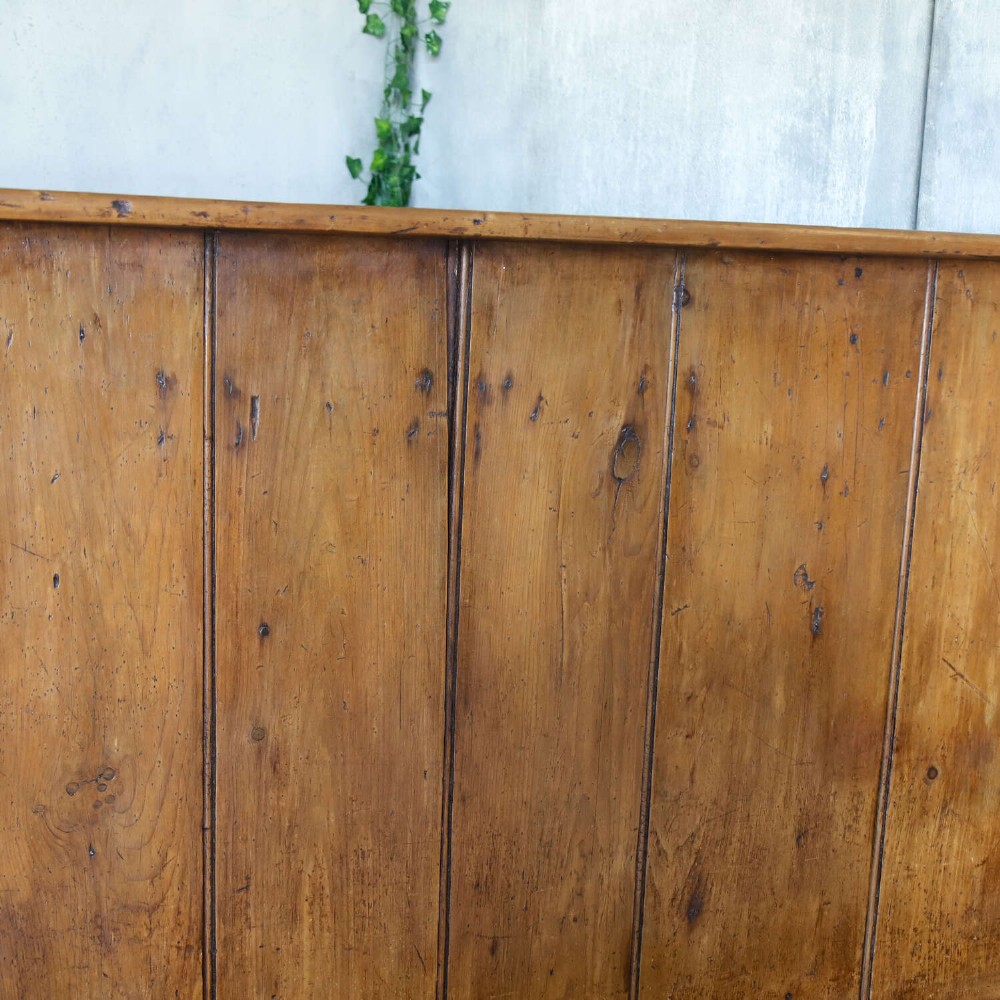 A 19th-century English country pine high-back settle bench with vertical timber panels and a warm honey brown finish. View VI