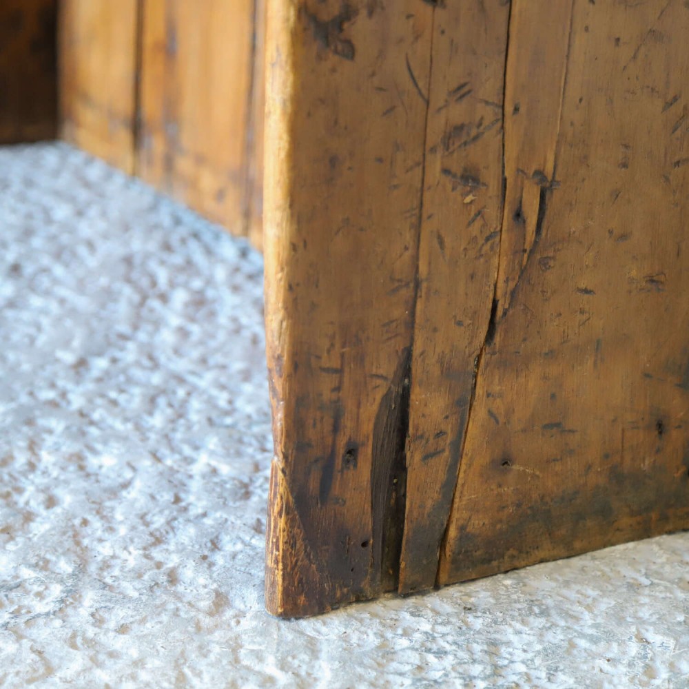 A 19th-century English country pine high-back settle bench with vertical timber panels and a warm honey brown finish. View X