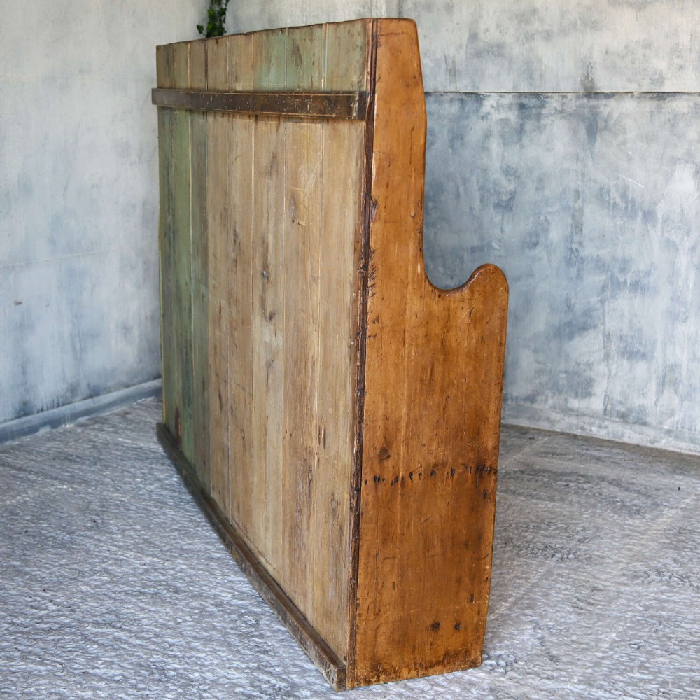 A 19th-century English country pine high-back settle bench with vertical timber panels and a warm honey brown finish. View XII