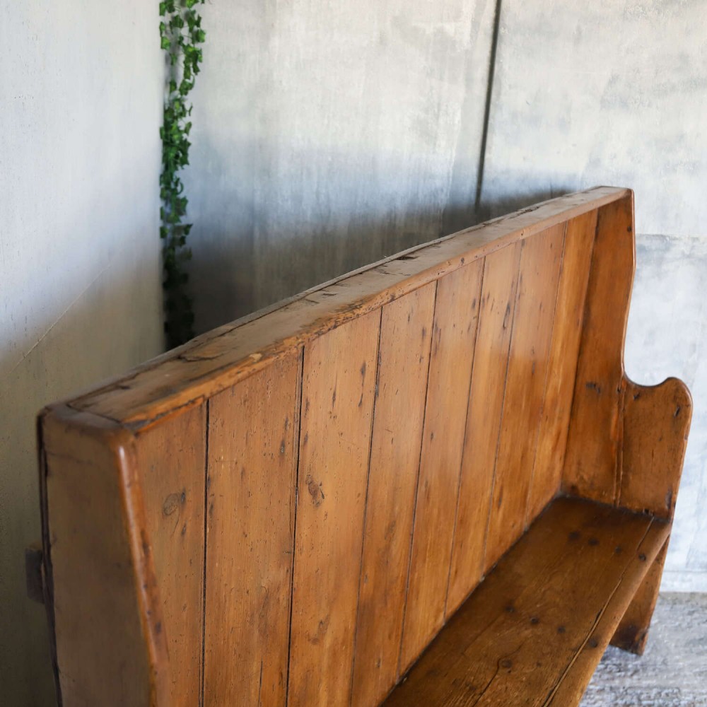 A 19th-century English country pine high-back settle bench with vertical timber panels and a warm honey brown finish. View XIII