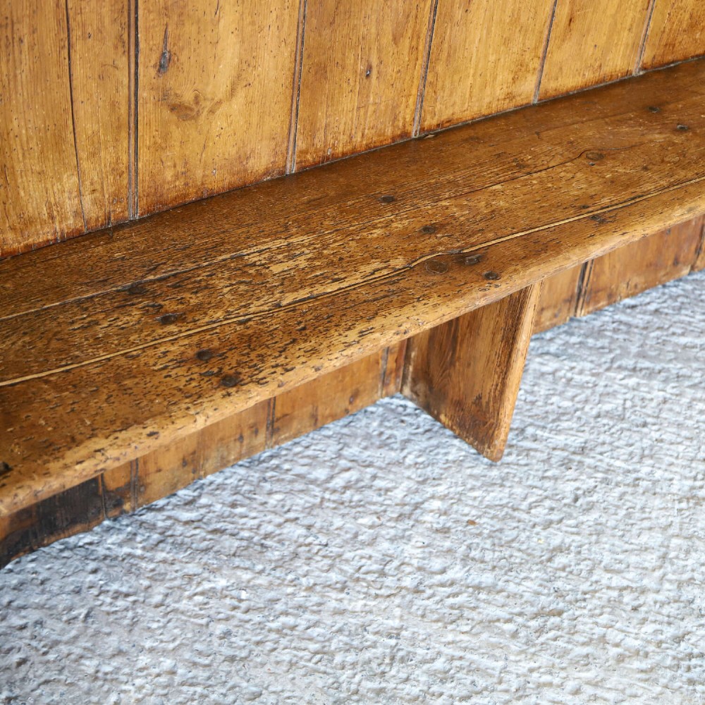 A 19th-century English country pine high-back settle bench with vertical timber panels and a warm honey brown finish. View XIV