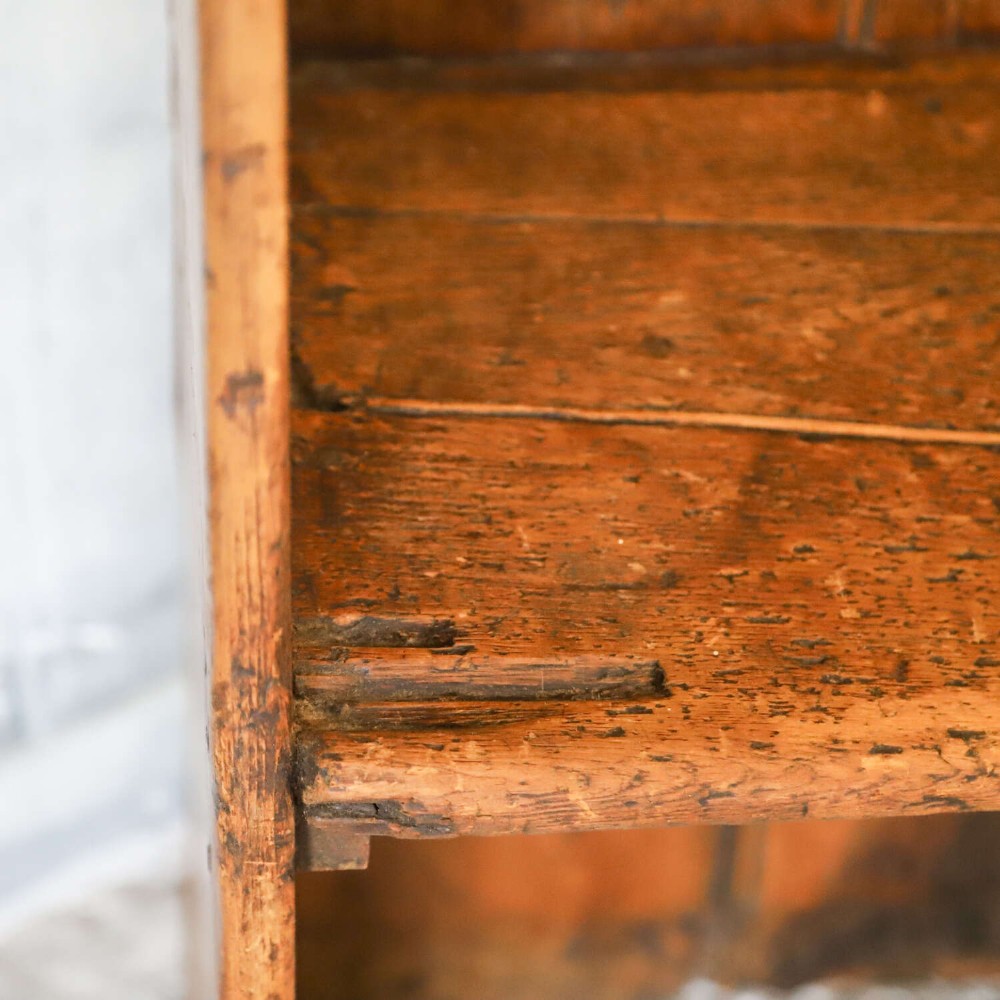 A 19th-century English country pine high-back settle bench with vertical timber panels and a warm honey brown finish. View XV
