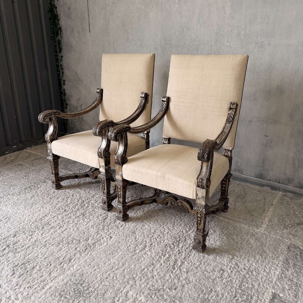 A pair of 19th-century Baroque-style throne armchairs featuring carved giltwood frames and neutral linen upholstery. View III
