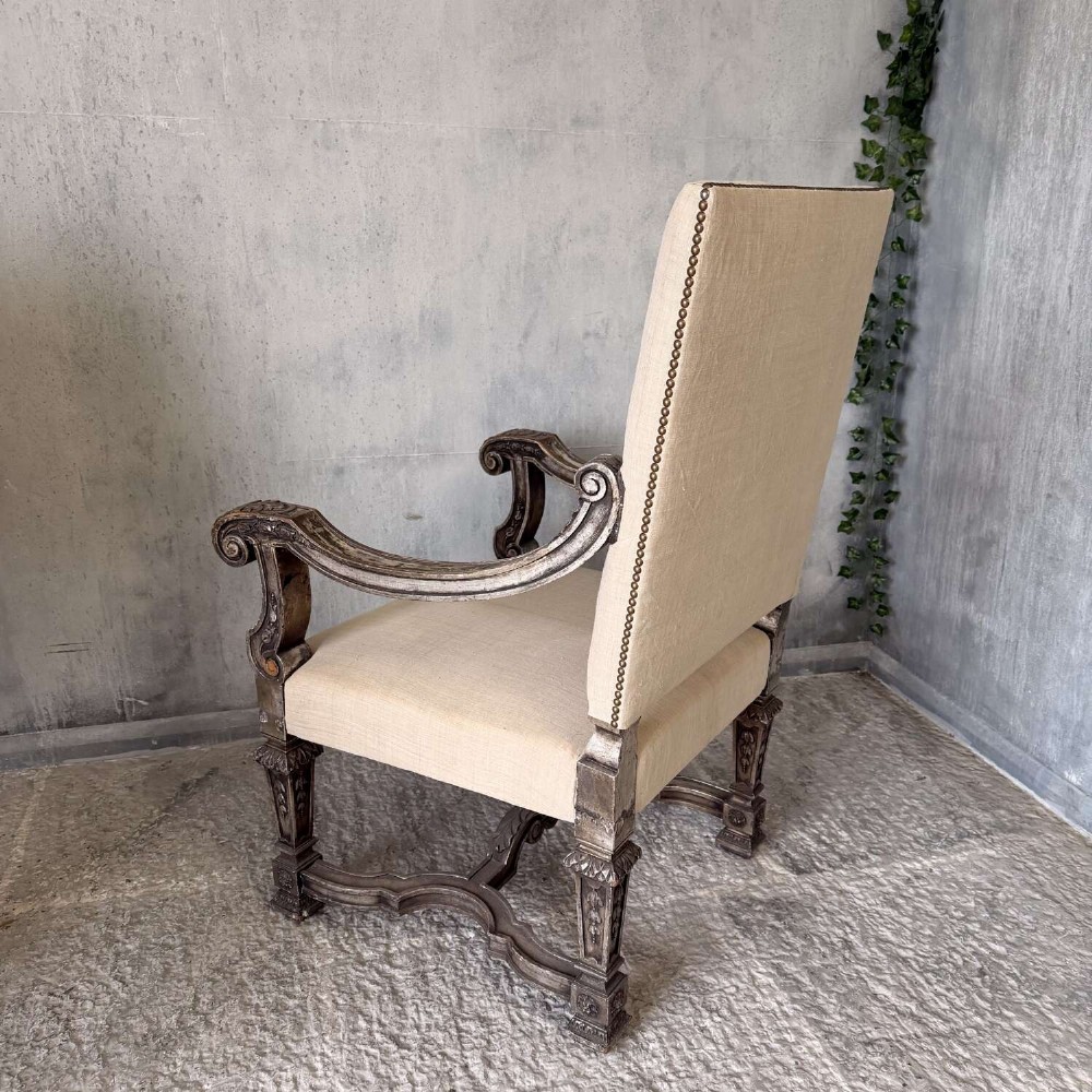 A pair of 19th-century Baroque-style throne armchairs featuring carved giltwood frames and neutral linen upholstery. View IV
