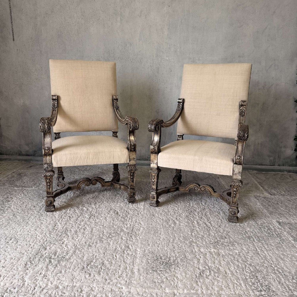 A pair of 19th-century Baroque-style throne armchairs featuring carved giltwood frames and neutral linen upholstery. View VII