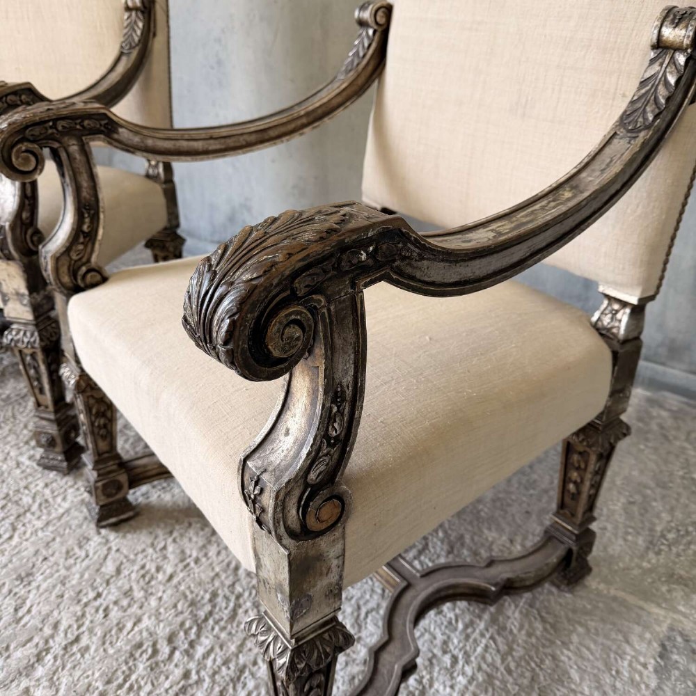 A pair of 19th-century Baroque-style throne armchairs featuring carved giltwood frames and neutral linen upholstery. View VIII