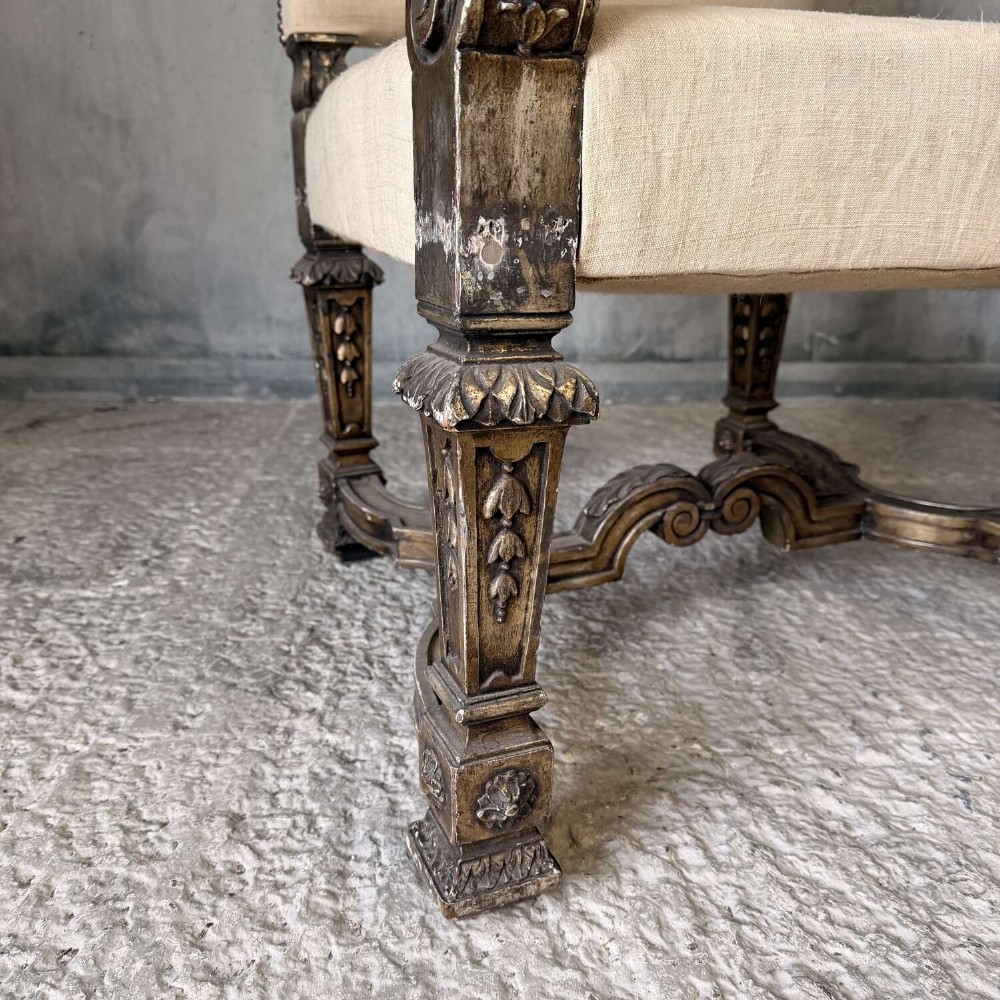 A pair of 19th-century Baroque-style throne armchairs featuring carved giltwood frames and neutral linen upholstery. View XI