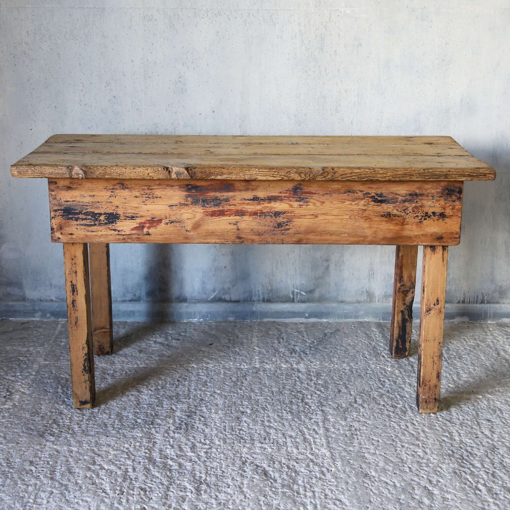A rustic early twentieth-century Welsh pine work table featuring a thick timber plank top, deep apron, and simple straight square legs with a distressed finish. View II
