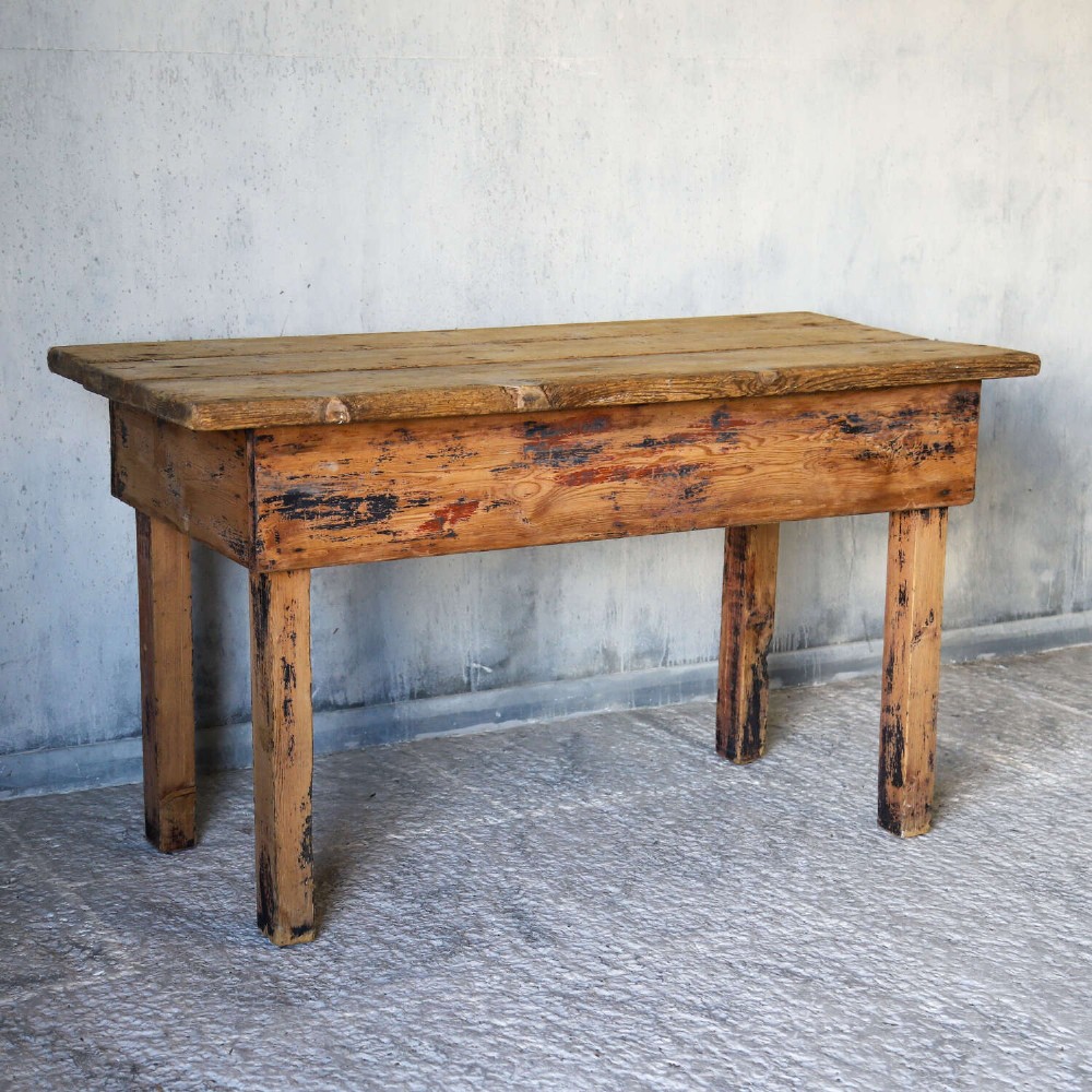 A rustic early twentieth-century Welsh pine work table featuring a thick timber plank top, deep apron, and simple straight square legs with a distressed finish. View III