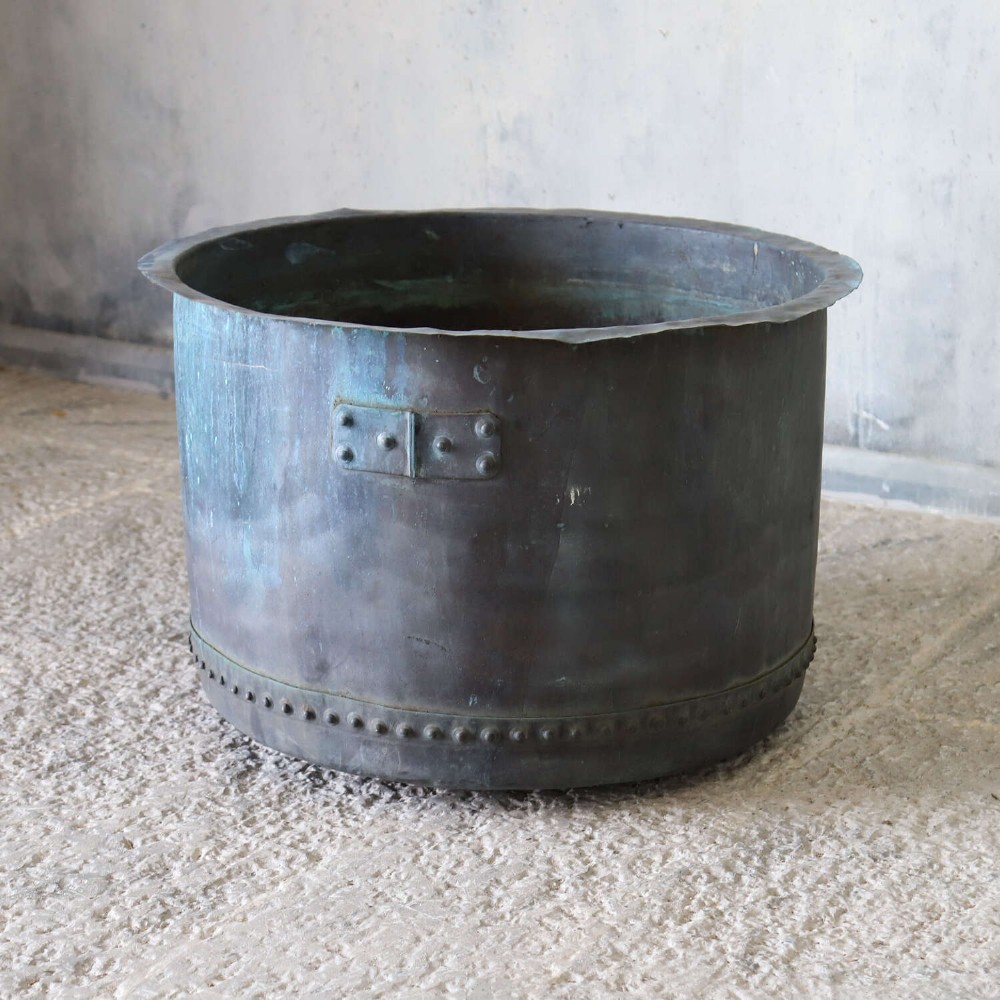 A large circular 19th-century copper tub featuring hand-riveted construction, side handles, and a blue-green verdigris patina. View III