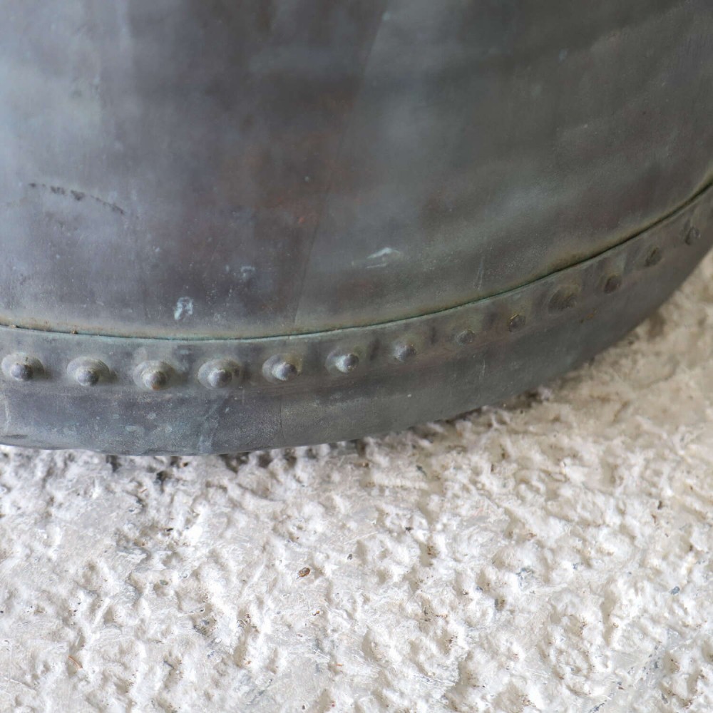 A large circular 19th-century copper tub featuring hand-riveted construction, side handles, and a blue-green verdigris patina. View IV