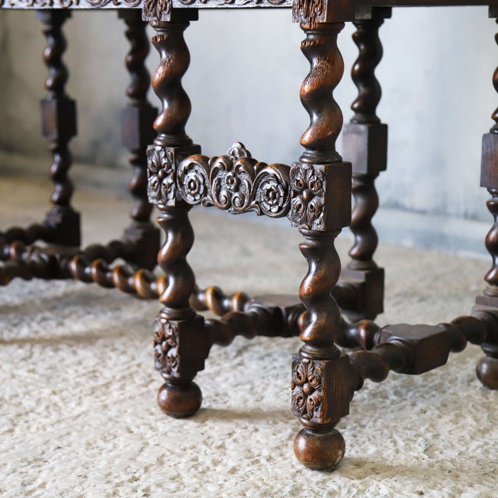 A dark oak Carolean Revival sideboard featuring two geometrically panelled drawers, intricate carving, and barley-twist legs connected by stretchers. View VIII