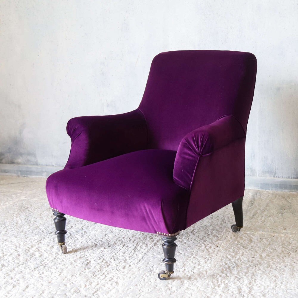 A Napoleon III armchair and matching Aesthetic Movement gypsy table upholstered in purple velvet with ebonised turned legs. View II