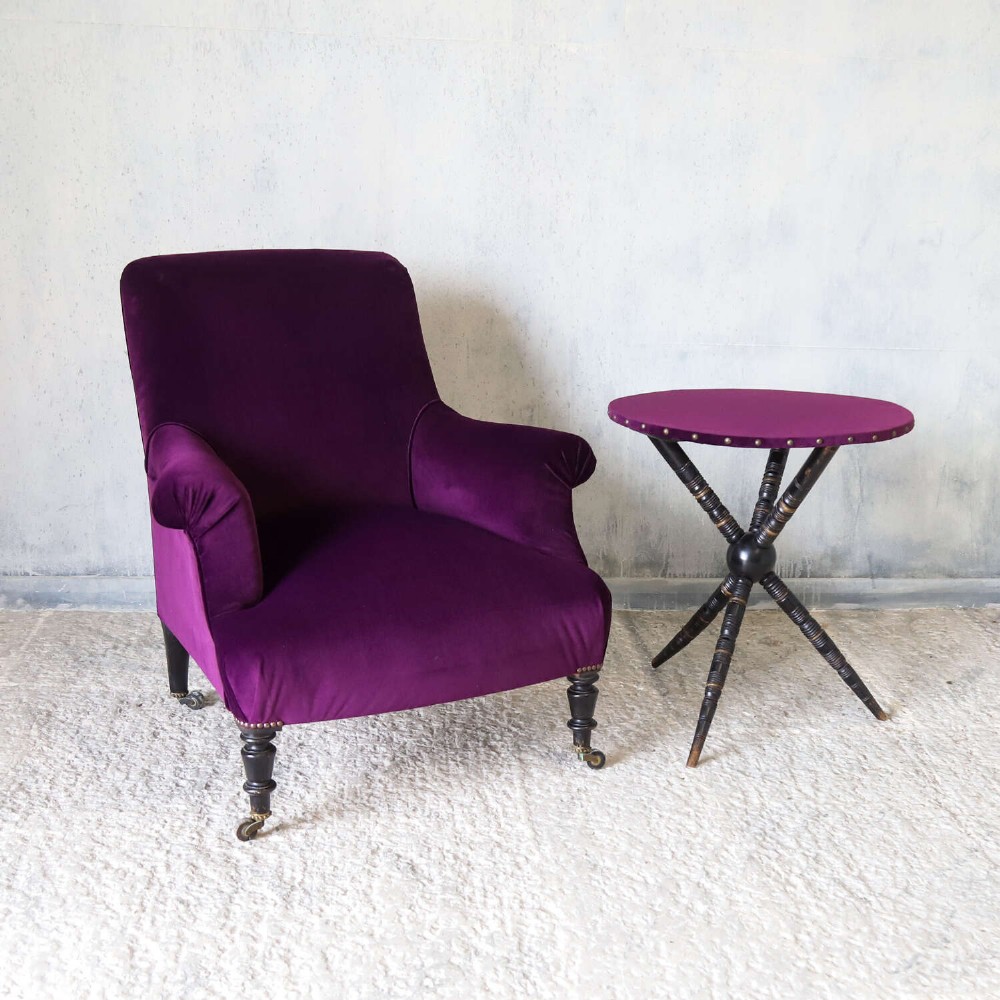 A Napoleon III armchair and matching Aesthetic Movement gypsy table upholstered in purple velvet with ebonised turned legs. View IV