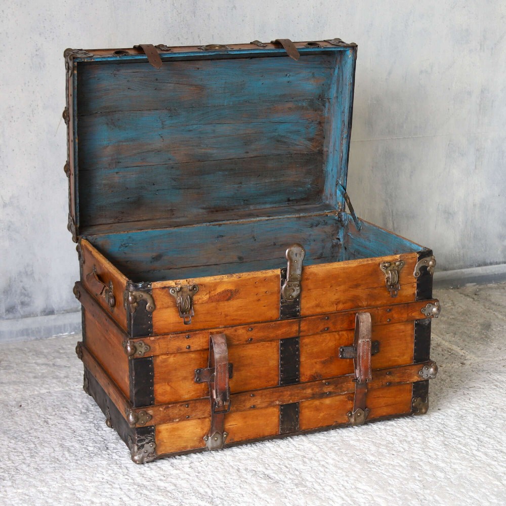 A 19th-century Victorian pine travelling trunk featuring wooden battens, iron corner brackets, central lock plate, and leather securing straps. View VIII