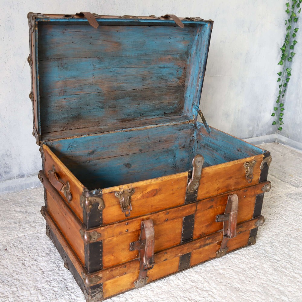 A 19th-century Victorian pine travelling trunk featuring wooden battens, iron corner brackets, central lock plate, and leather securing straps. View IX