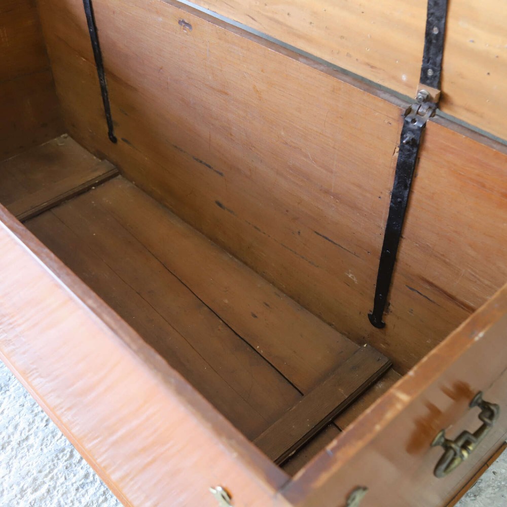 An 18th-century walnut colonial chest featuring decorative brass corner brackets, a central brass escutcheon, and dark turned feet. View VII