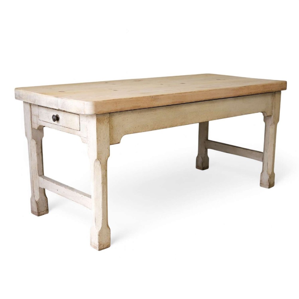 A 19th-century English country house prep table featuring a thick natural timber top, an off-white painted wooden base, a side drawer, and low stretchers.