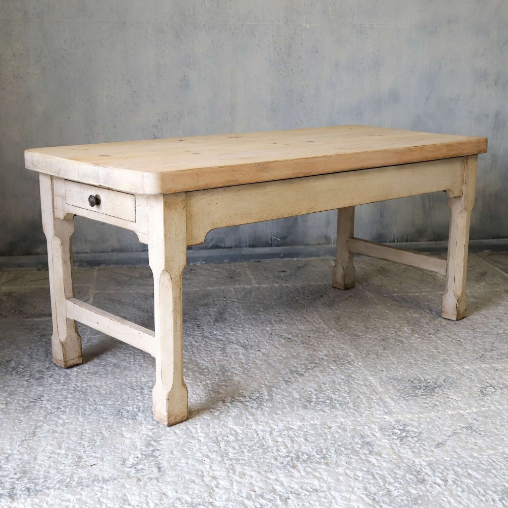 A 19th-century English country house prep table featuring a thick natural timber top, an off-white painted wooden base, a side drawer, and low stretchers. View III