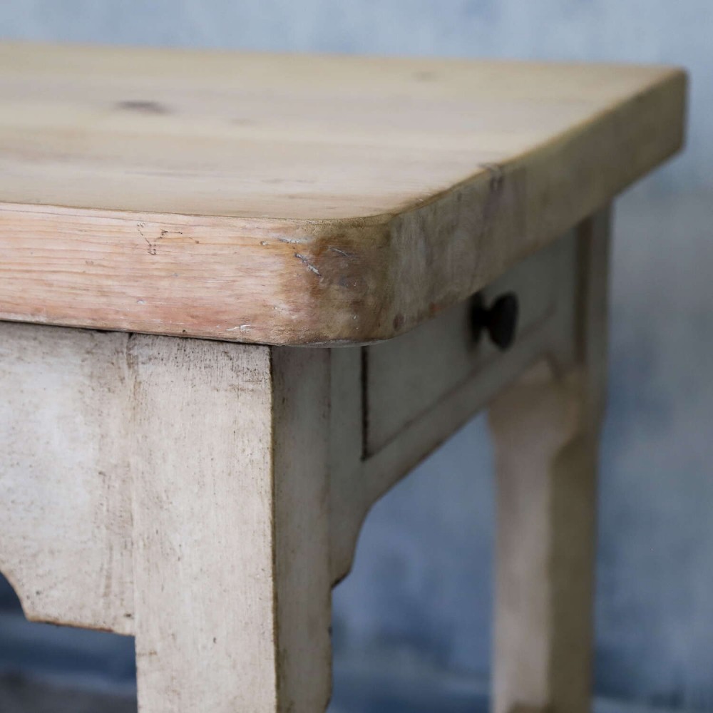 A 19th-century English country house prep table featuring a thick natural timber top, an off-white painted wooden base, a side drawer, and low stretchers. View V