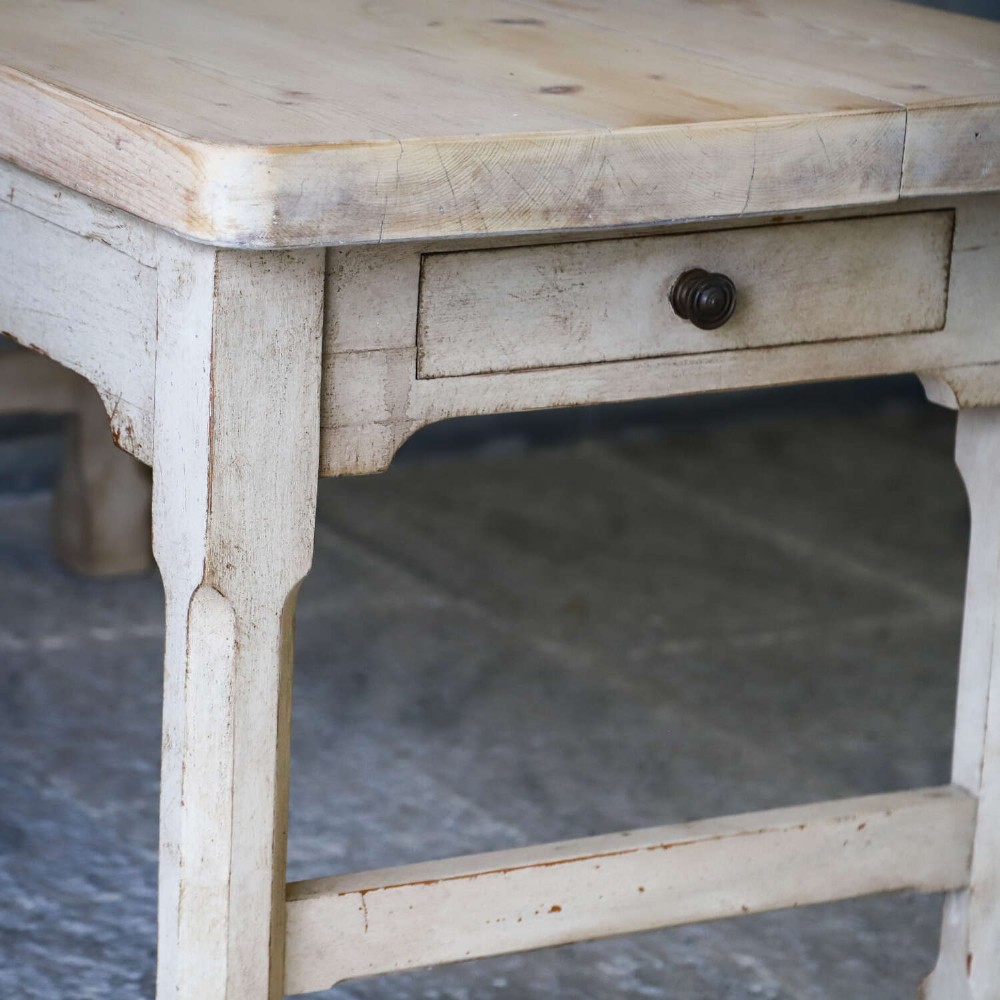 A 19th-century English country house prep table featuring a thick natural timber top, an off-white painted wooden base, a side drawer, and low stretchers. View VII