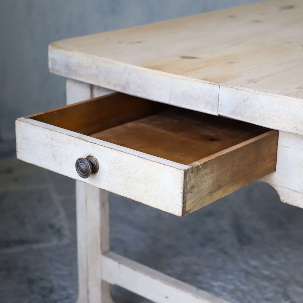 A 19th-century English country house prep table featuring a thick natural timber top, an off-white painted wooden base, a side drawer, and low stretchers. View X