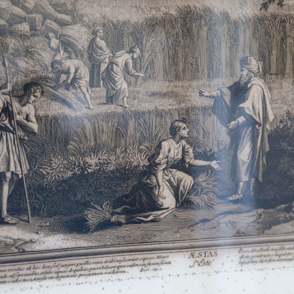 A framed monochrome engraving depicting a classical harvest landscape scene with figures working in a field beneath trees, enclosed in a dark wood frame. View IV