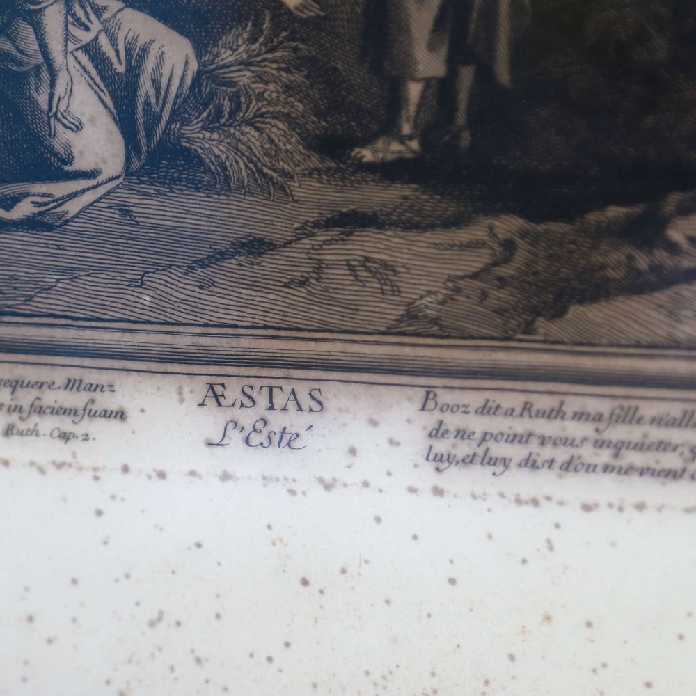 A framed monochrome engraving depicting a classical harvest landscape scene with figures working in a field beneath trees, enclosed in a dark wood frame. View XI