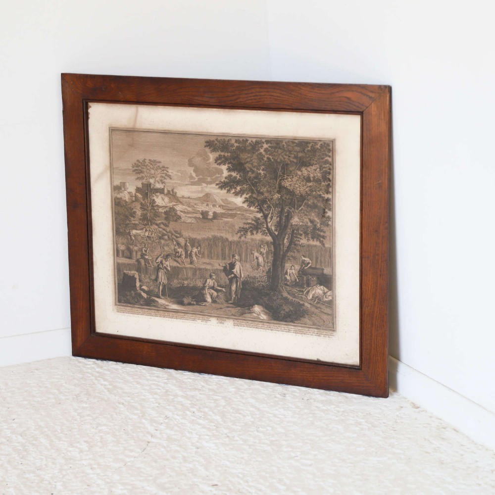 A framed monochrome engraving depicting a classical harvest landscape scene with figures working in a field beneath trees, enclosed in a dark wood frame. View XIV