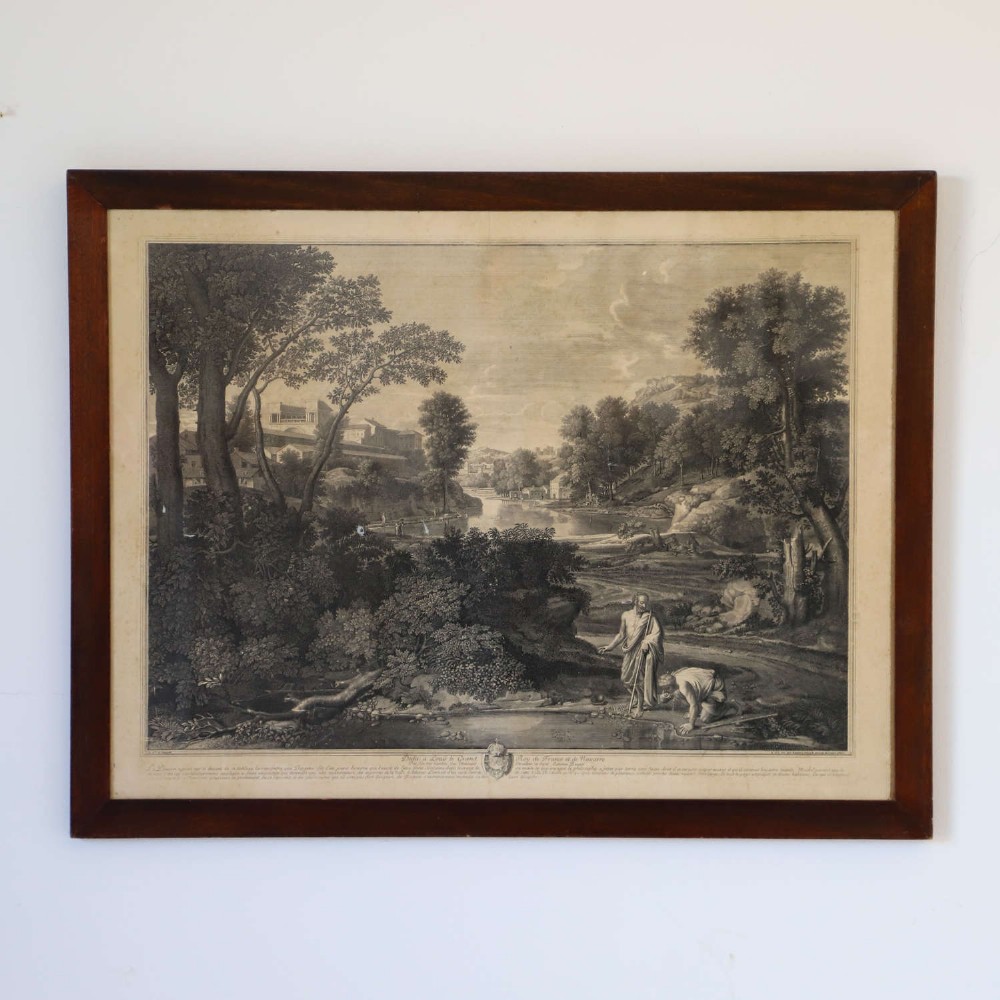 An 18th-century monochrome French engraving depicting a classical landscape with figures beside a body of water, housed in a plain dark wood frame. View II