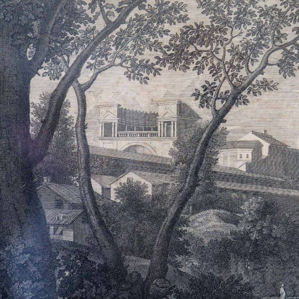 An 18th-century monochrome French engraving depicting a classical landscape with figures beside a body of water, housed in a plain dark wood frame. View V