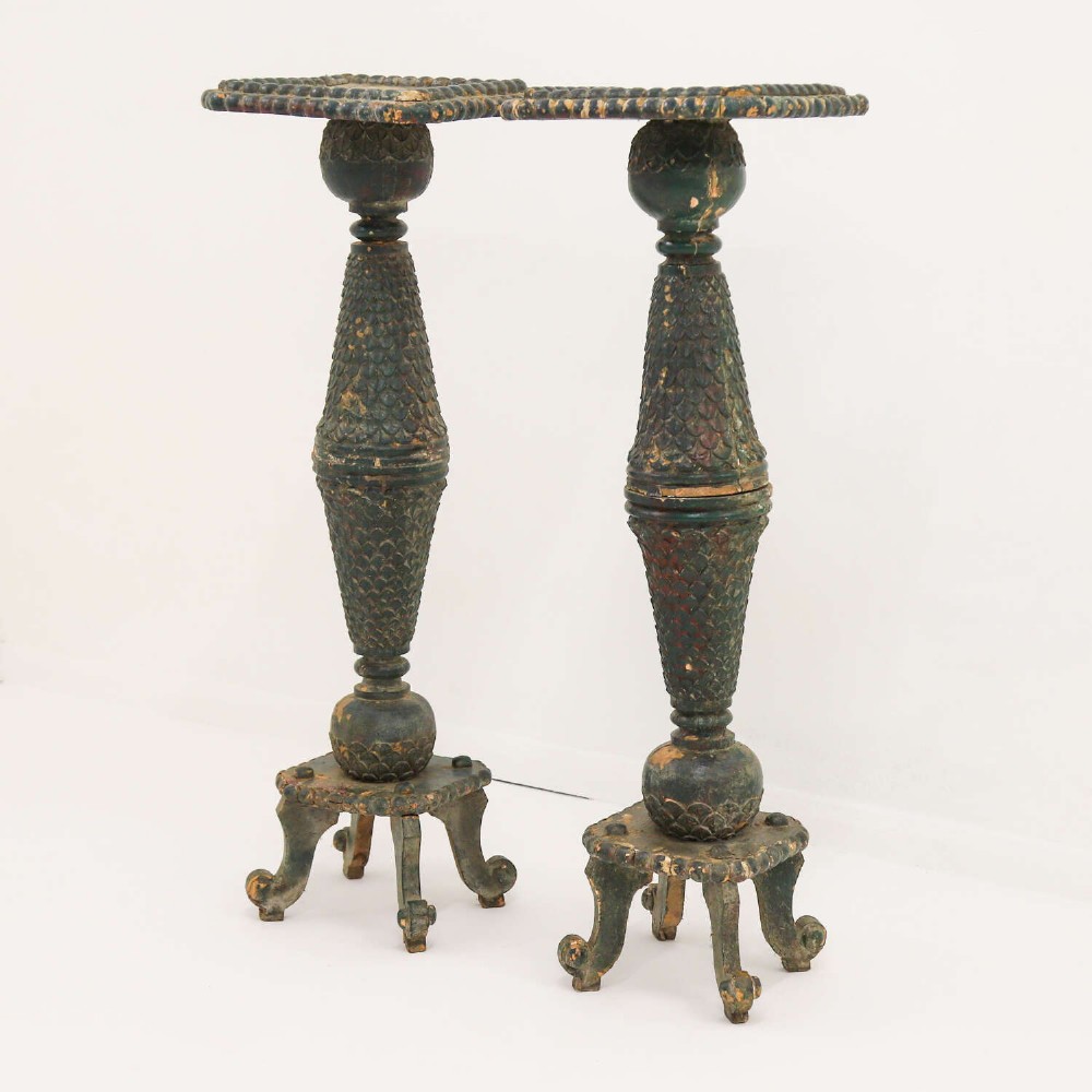A pair of carved wooden torcheres featuring fish-scale carved baluster columns, square top platforms with beaded borders, scrolled feet, and distressed original green paint. View III
