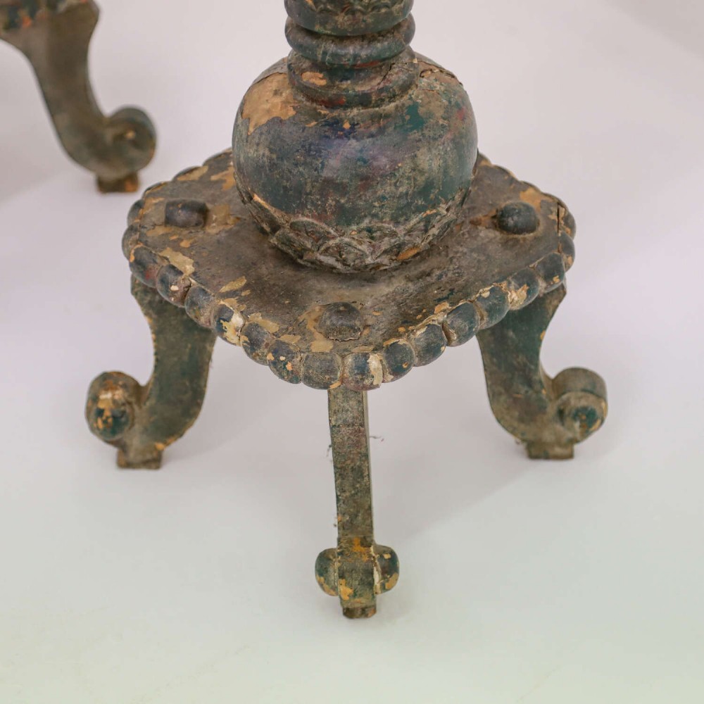 A pair of carved wooden torcheres featuring fish-scale carved baluster columns, square top platforms with beaded borders, scrolled feet, and distressed original green paint. View VIII