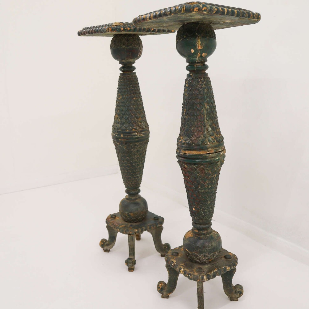 A pair of carved wooden torcheres featuring fish-scale carved baluster columns, square top platforms with beaded borders, scrolled feet, and distressed original green paint. View XI