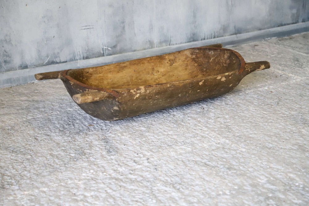 A hand-carved 19th-century French wooden dough trough with integrated handles and a weathered surface. View II