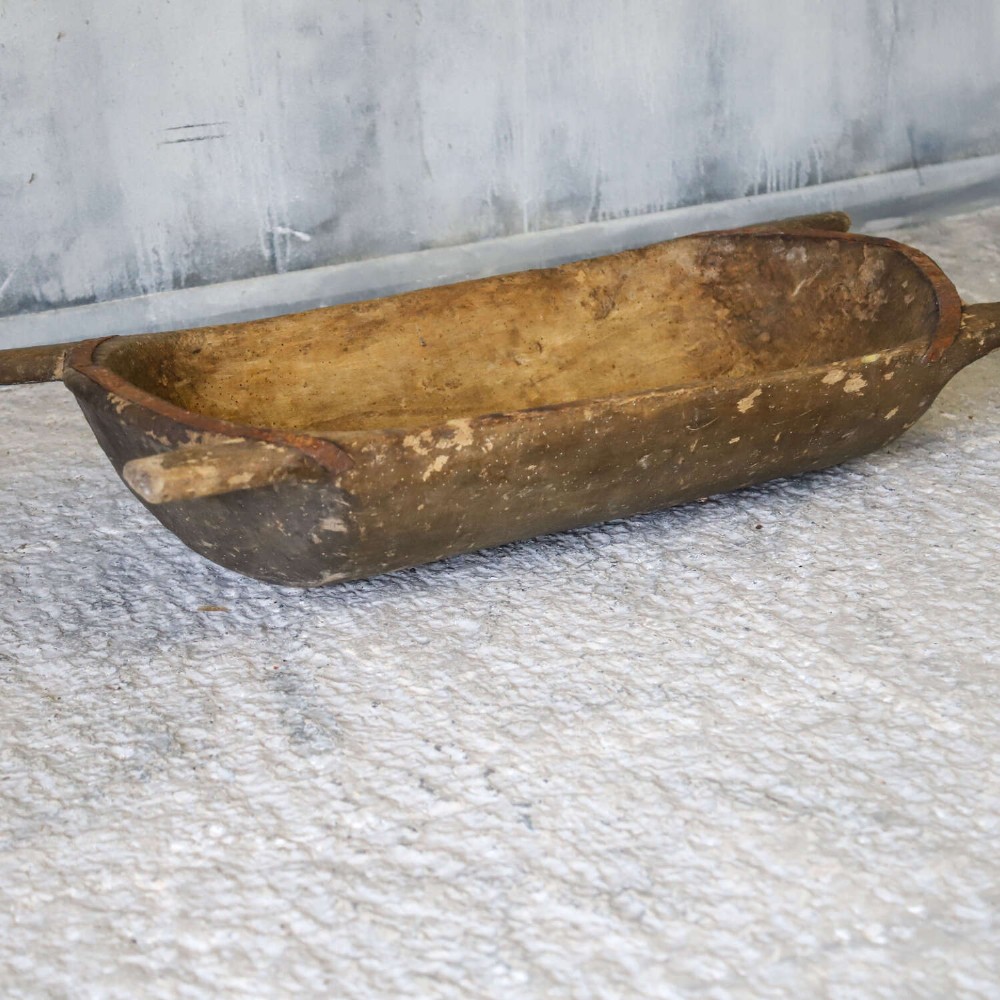 A hand-carved 19th-century French wooden dough trough with integrated handles and a weathered surface. View IV