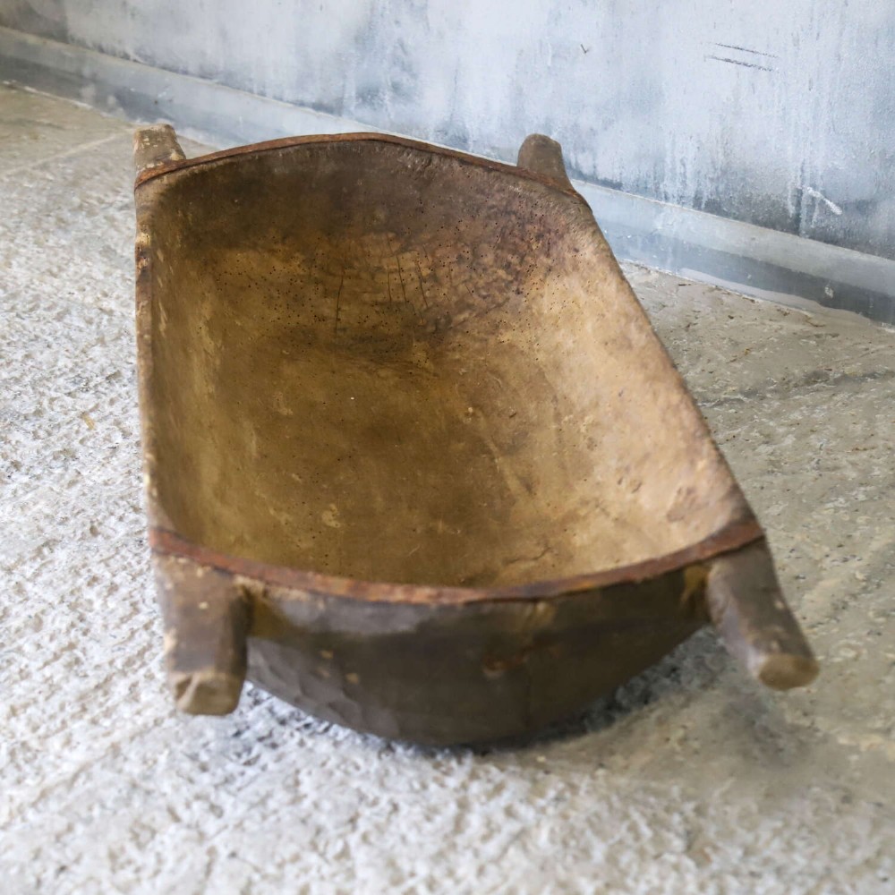A hand-carved 19th-century French wooden dough trough with integrated handles and a weathered surface. View VI