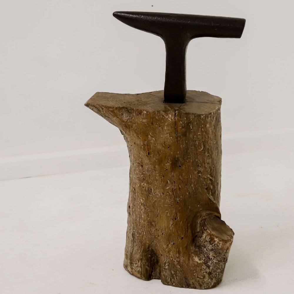 A nineteenth-century T-shaped wrought iron farriers anvil mounted into a natural carved fruitwood log trunk. View II