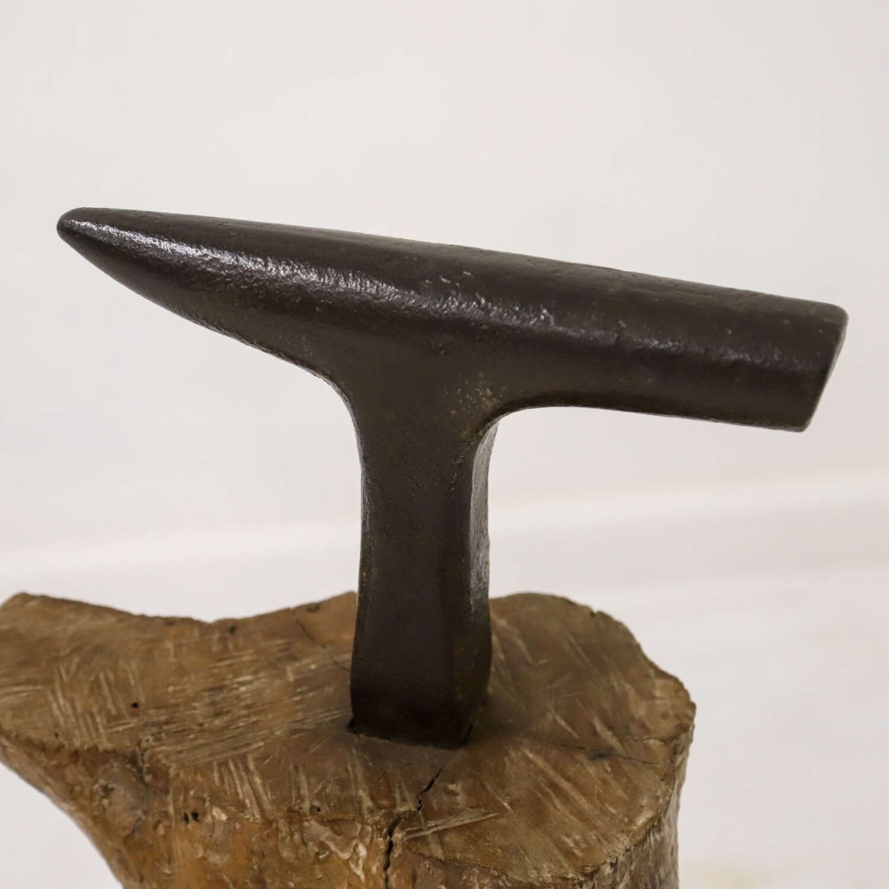 A nineteenth-century T-shaped wrought iron farriers anvil mounted into a natural carved fruitwood log trunk. View III
